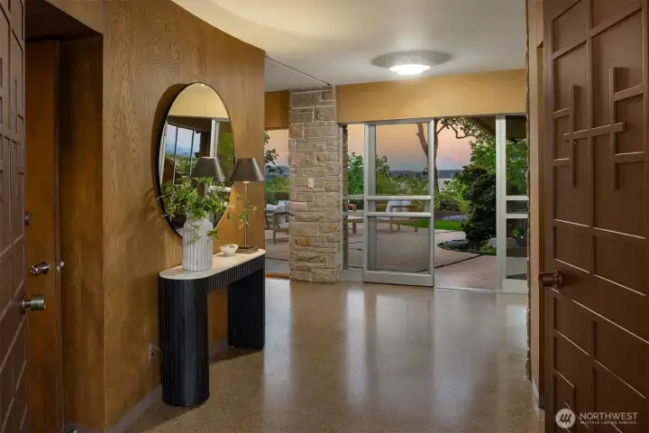 The moody entry welcomes you and is understated for the home and property.