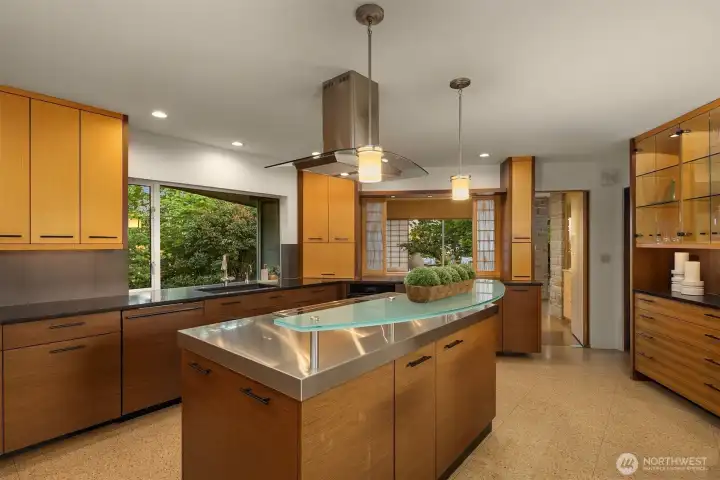 The gourmet kitchen was extensively remodeled in 2007 by Gaspar Construction.  It was designed with forward thinking using glass, steel and quartz for the counters and bamboo for the cabinets to mimic the mid century modern design and asian inspiration.