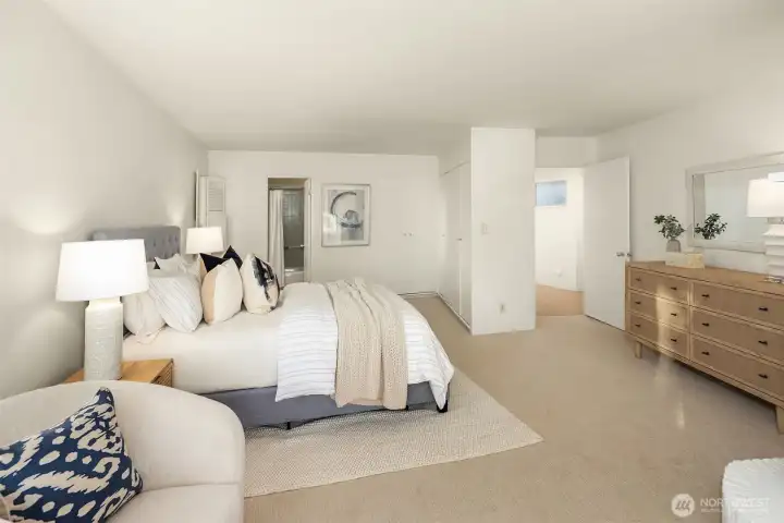The primary suite with a wall of closets in its, "dressing area".