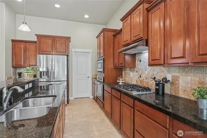 Functional kitchen design, pantry, double sink, granite countertops.