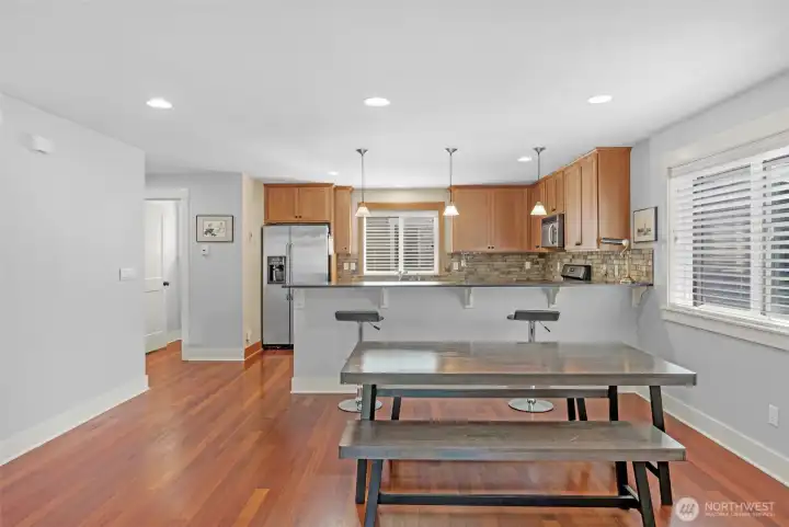 View from living to dining/kitchen as well as the convenient half bath on the side.