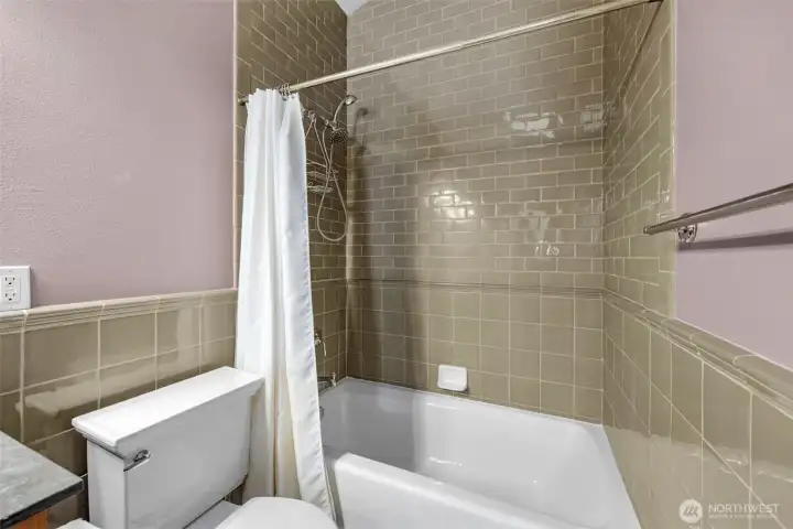 Quality tiling wraps the bathroom, including the shower area