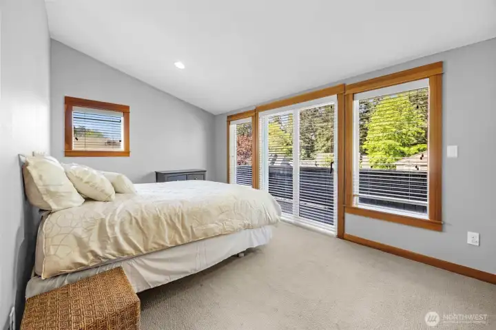Second bedroom on the top floor. With access to the balcony, this may be considered the primary bedroom between the two bedrooms