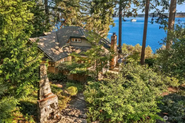 The home is nestled amongst tall trees with gorgeous southern views of Puget Sound, Mt. Rainier and Tacoma.