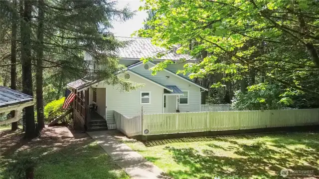 Front of home with side enclosed yard, w/ separate entrance