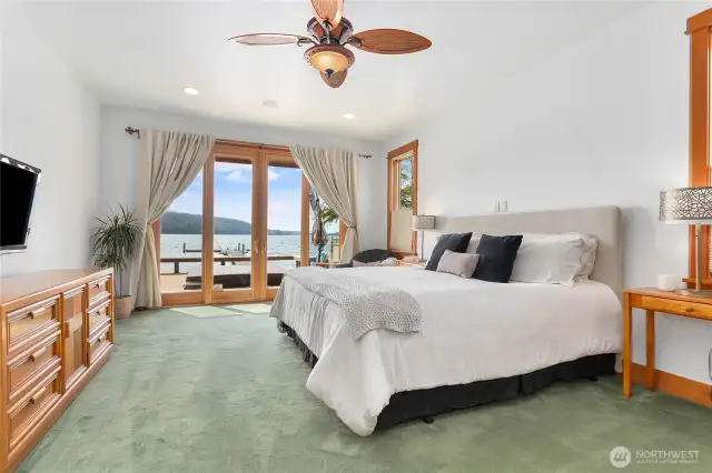 Main floor primary bedroom opens up to the hot tub/deck