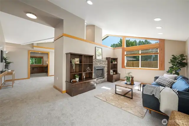 Main house living room with custom fireplace surround and built-ins. Large windows for natural light.
