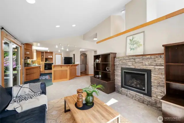 Main house living room with custom fireplace surround and built-ins. Large windows for natural light.