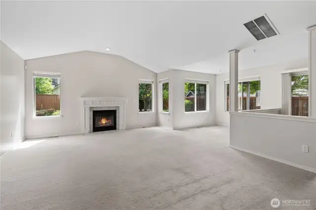 Great Room with Vaulted Ceilings and Gas Fireplace. Sitting Room to the right is great as WFH space.
