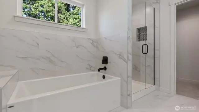 Primary Bath has tile walls and flooring.
