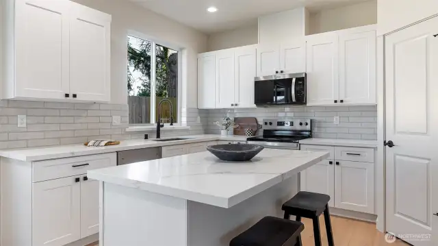 Designer Kitchen has large island and walk in pantry.