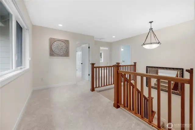 The landing at the top of the stairs is large and expansive for a desk, library, reading nook etc.