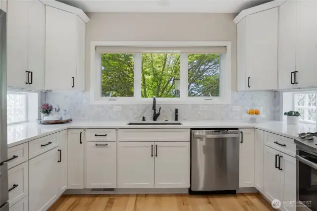 The updated kitchen is the heart of the home - beautiful, bright cabinets and lots of storage.