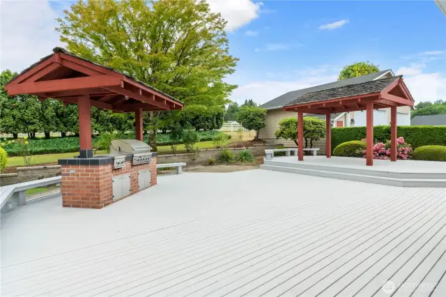 Huge deck with dueling pagodas. One on left has both bar-b-que grill and cook top, with elevated eating area on the right. Was previously a jacuzzi and could be transformed back in the future