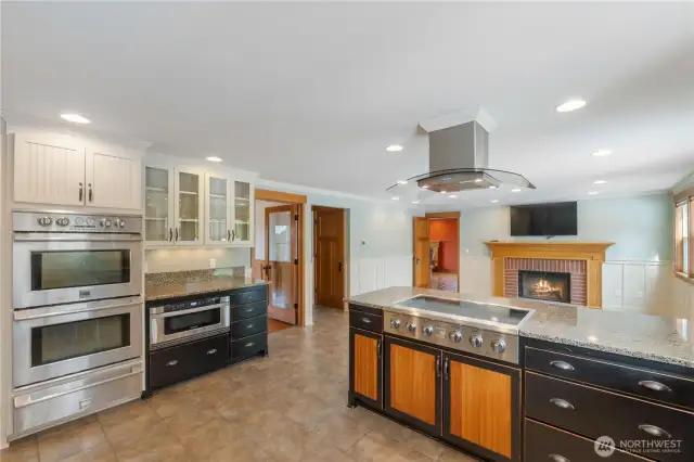 Incredibly updated island kitchen w/custom cabinets, dual ovens & warming oven below, built in microwave leading to glass stovetop on the right. Many pull out drawers for wonderful storage & ease of access!