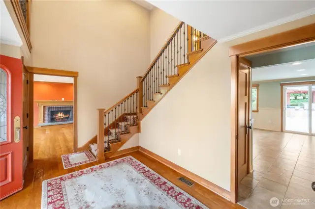 Tall 2 story entrance for that wow factor and stylish railing leading you upstairs. Through rugs stay, match the rugs on the stairs.