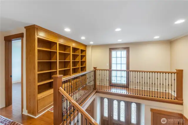 Upstairs landing with built in book cabinets leading to door going onto the 2nd story deck looking at great view