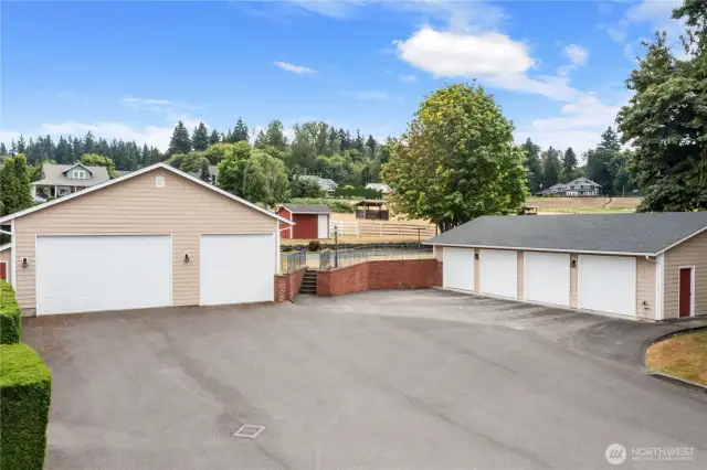 3 Car garage on the left with left side having storage over the 2 car garage door w/right single door open 2 levels high and is perfect for a lift if desired. Heated 4 Car garage on the right