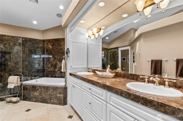 Primary ensuite bath with separate jetted tub & shower, & marble tiling
