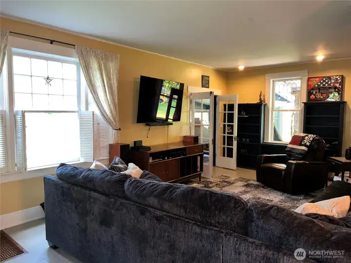 Double doors from the enclosed patio (currently used as an office) opens to your spacious living room area. Complete with hardwood floors, built in cabinetry and light that pours in through the original lead windows.