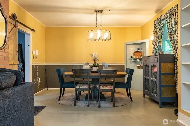 Enjoy meals and gatherings in the separate dining area. Barn door to the left in the dining room gives you access to the remodeled kitchen.