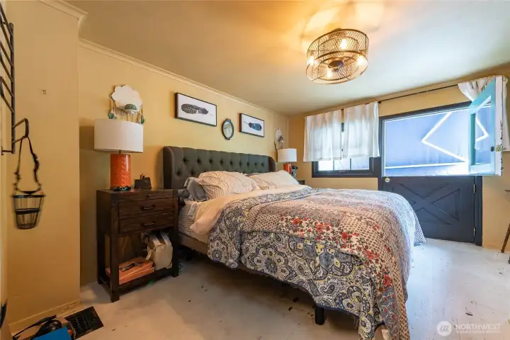 Large bedroom upstairs with private balcony to enjoy your morning coffee, overlooking the serene back yard. Can comfortable fit king size bed as pictured.