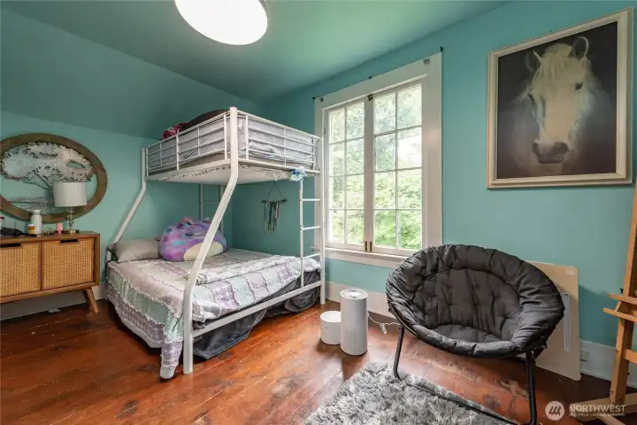 One of the three bedrooms upstairs. All with hardwood floors and great yard views.