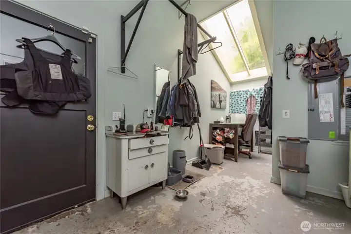 Large mud room with skylights and tons of potential. Door to the left leads you into the two car garage. Not pictured is the door to the right that takes you into the laundry room.