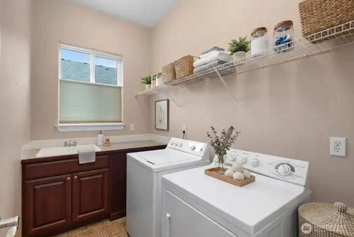 Laundry room complete with a convenient sink.