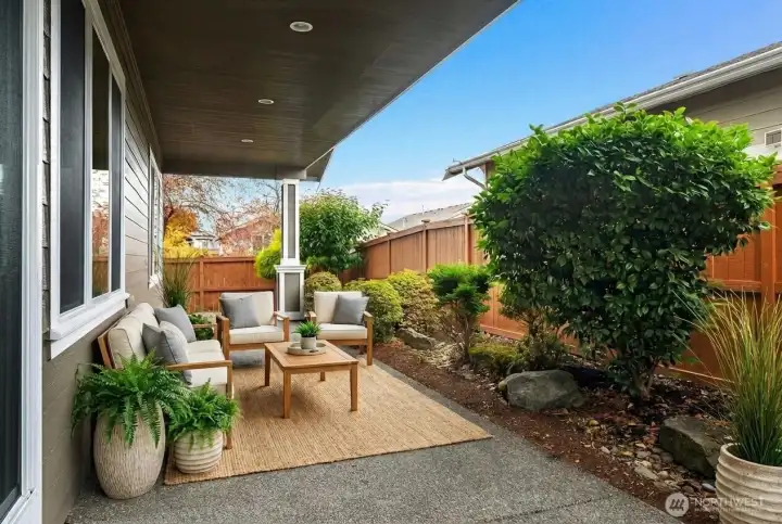 Beautifully maintained exterior with fresh paint (2021), a large private covered patio, and a fully fenced yard updated in 2023.