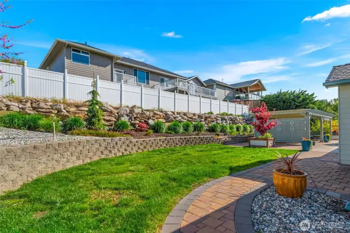 Back yard professionally landscaped - brick walkway