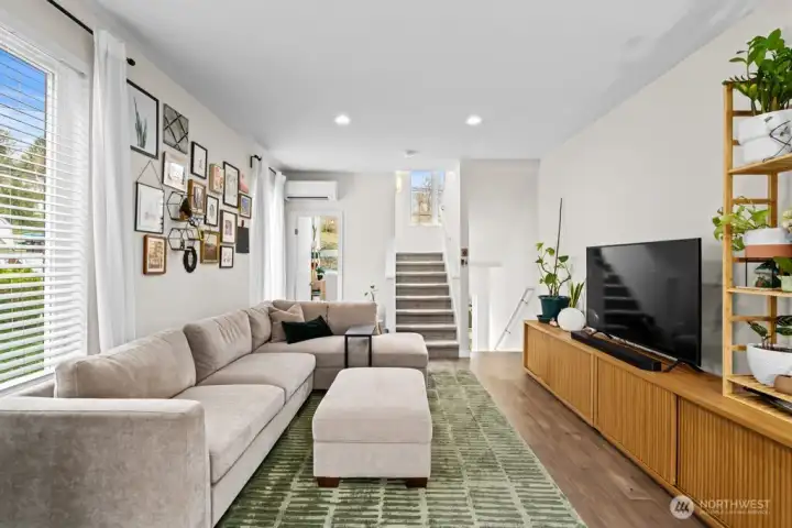 View from kitchen to the half bath and stairs going up/down