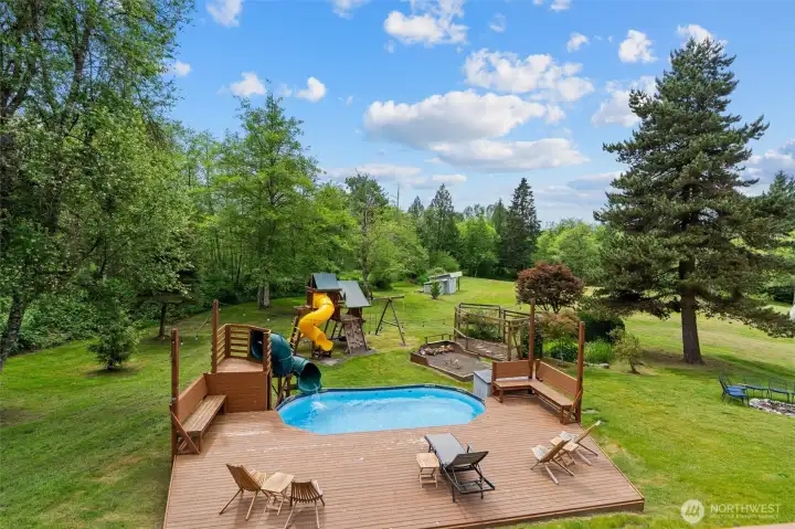Pool with water slide and deck for entertaining