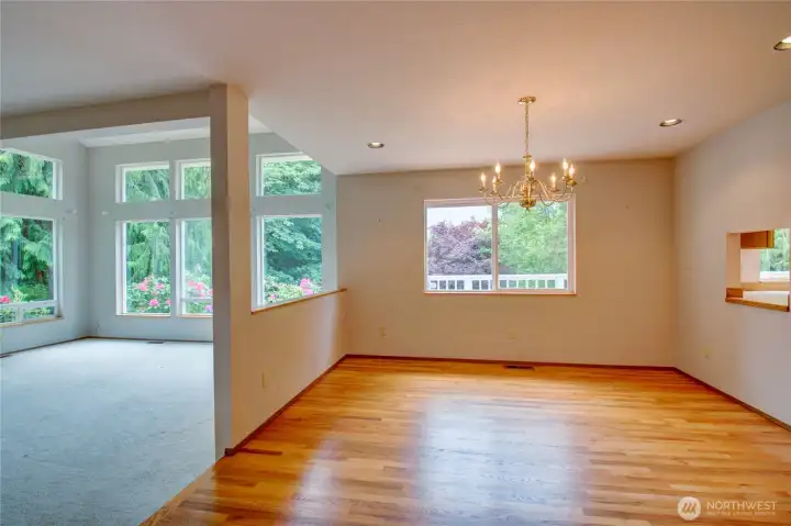 To the left is a large livingroom with picture windows and wood burning fireplace. To the right with wood floors is main (formal) dining room. To the left is a large livingroom with picture windows and wood burning fireplace. To the right with wood floors is main (formal) dining room.