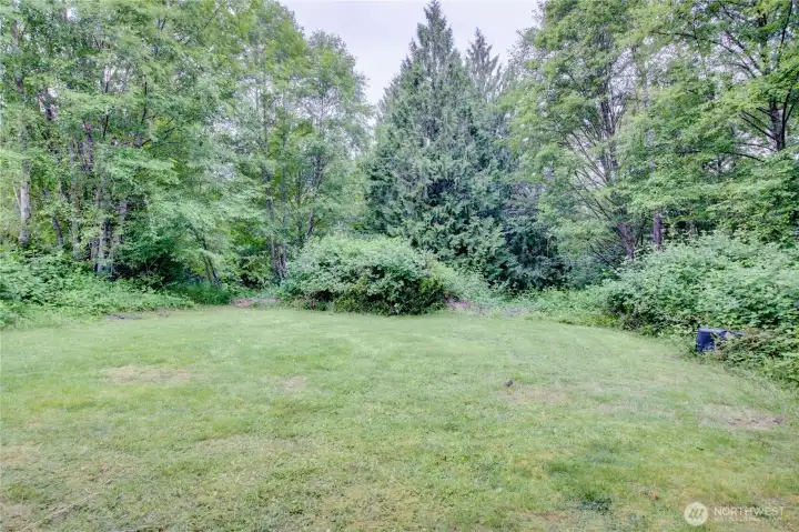 area outside the large shop, property slopes with a trail down to a seasonal creek area outside the large shop, property slopes with a trail down to a seasonal creek