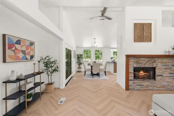 Stunning herringbone flooring on the main floor. The living room wraps around to the dining and kitchen Stunning herringbone flooring on the main floor. The living room wraps around to the dining and kitchen