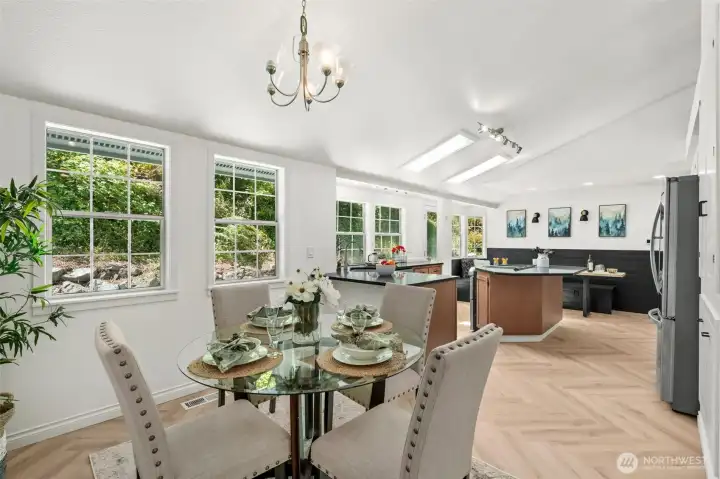 Dining room steps out to covered patio and opens to kitchen with vaulted ceilings Dining room steps out to covered patio and opens to kitchen with vaulted ceilings