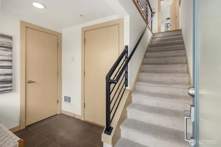 The entry level offers convenient garage access and generous storage, creating a practical drop zone for bikes, outdoor gear, and everyday essentials.