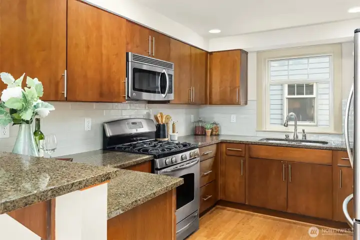 The chef's kitchen features granite countertops, stainless steel appliances, and abundant storage—perfect for everything from quick mornings to dinner parties with friends.