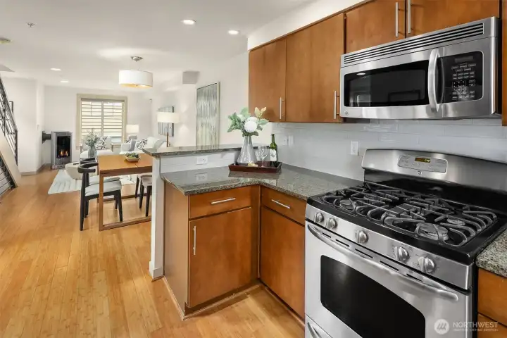 Open sightlines connect the kitchen, dining, and living areas, creating an effortless flow for gathering, entertaining, and everyday living.