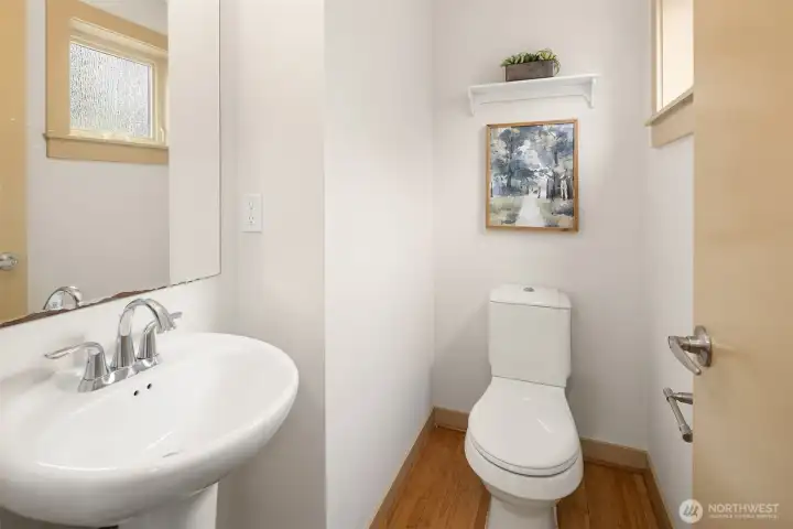 Convenient main-level powder room, thoughtfully positioned for guests and everyday functionality.