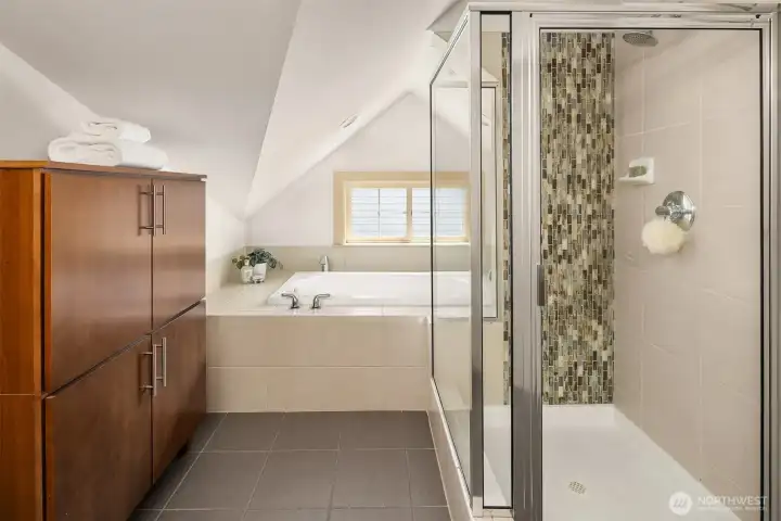 Generous proportions and timeless finishes create a tranquil primary bath retreat within the home's private upper-level sanctuary.