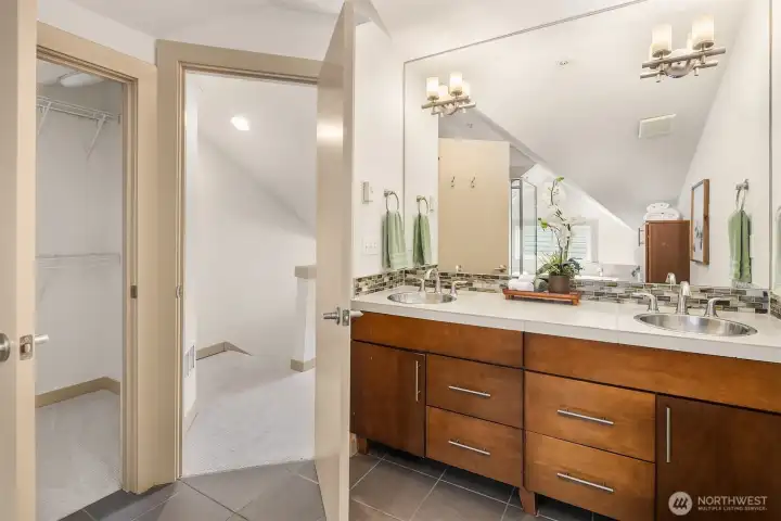Dual vanities, generous storage, and a walk-in closet enhance the comfort and functionality of the private primary retreat.
