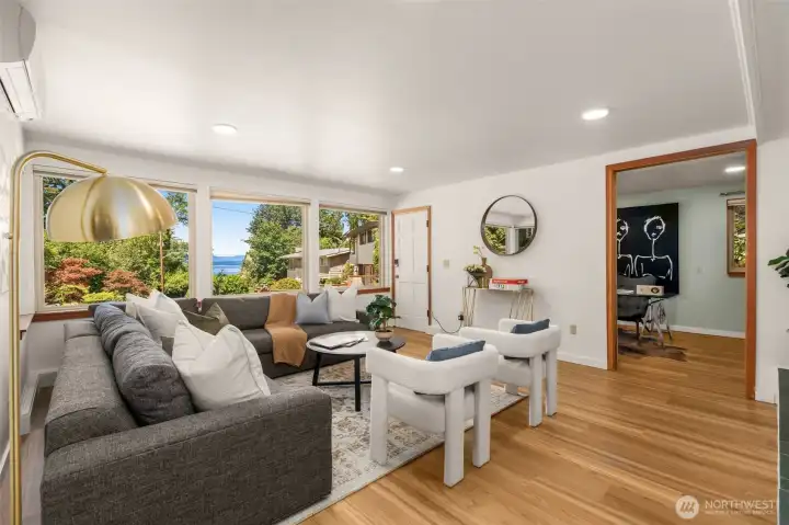 Rec room on lower level with oversized windows showcasing Puget Sound views. New Luxury Vinyl Plank flooring throughout Rec room on lower level with oversized windows showcasing Puget Sound views. New Luxury Vinyl Plank flooring throughout