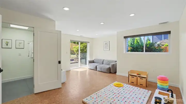 Lower-level rec room with additional access to the backyard.