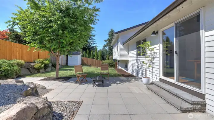 Thoughtfully designed outdoor spaces include expansive paver patios, mature landscaping, a level lawn area, and room to relax, gather, and enjoy the outdoors.