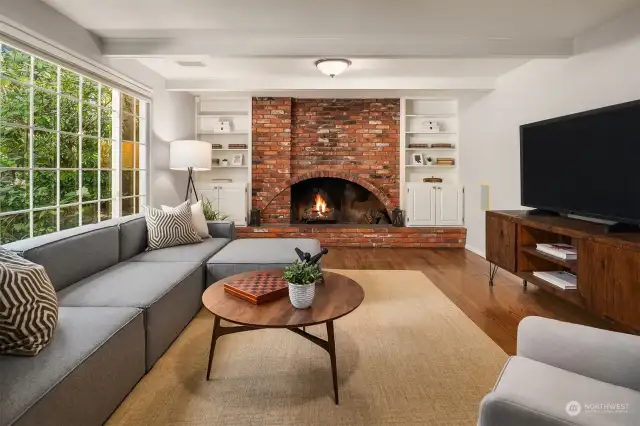 Relax around the fireside in the comfy family room with built-in library shelving.