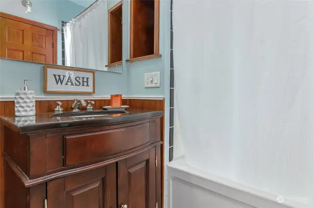 Unwind and soak away the day in this charming bathroom, complete with a bathtub.