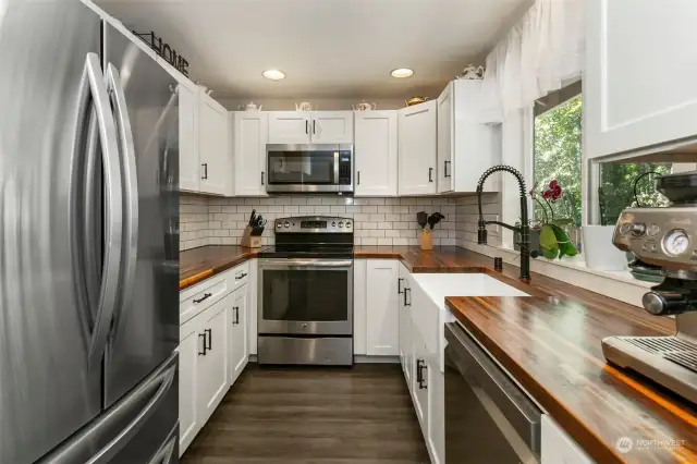 Kitchen with butcher block countertops, stainless steel appliances and updated cabinets