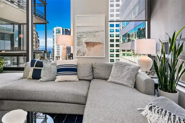 Walls of windows allow great natural light and peekaboo views of downtown and the waterfront from inside the condo.